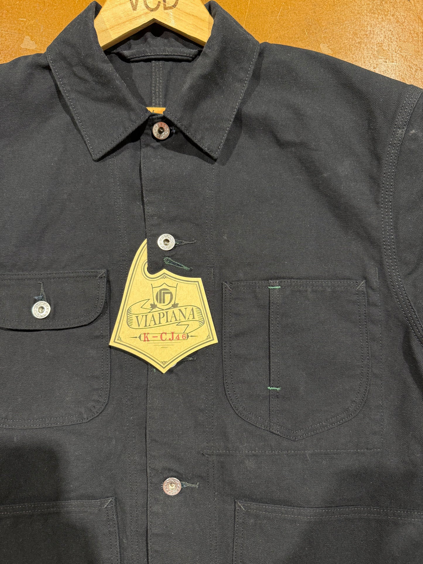 Keymaster Black Chore Coat laid flat on table