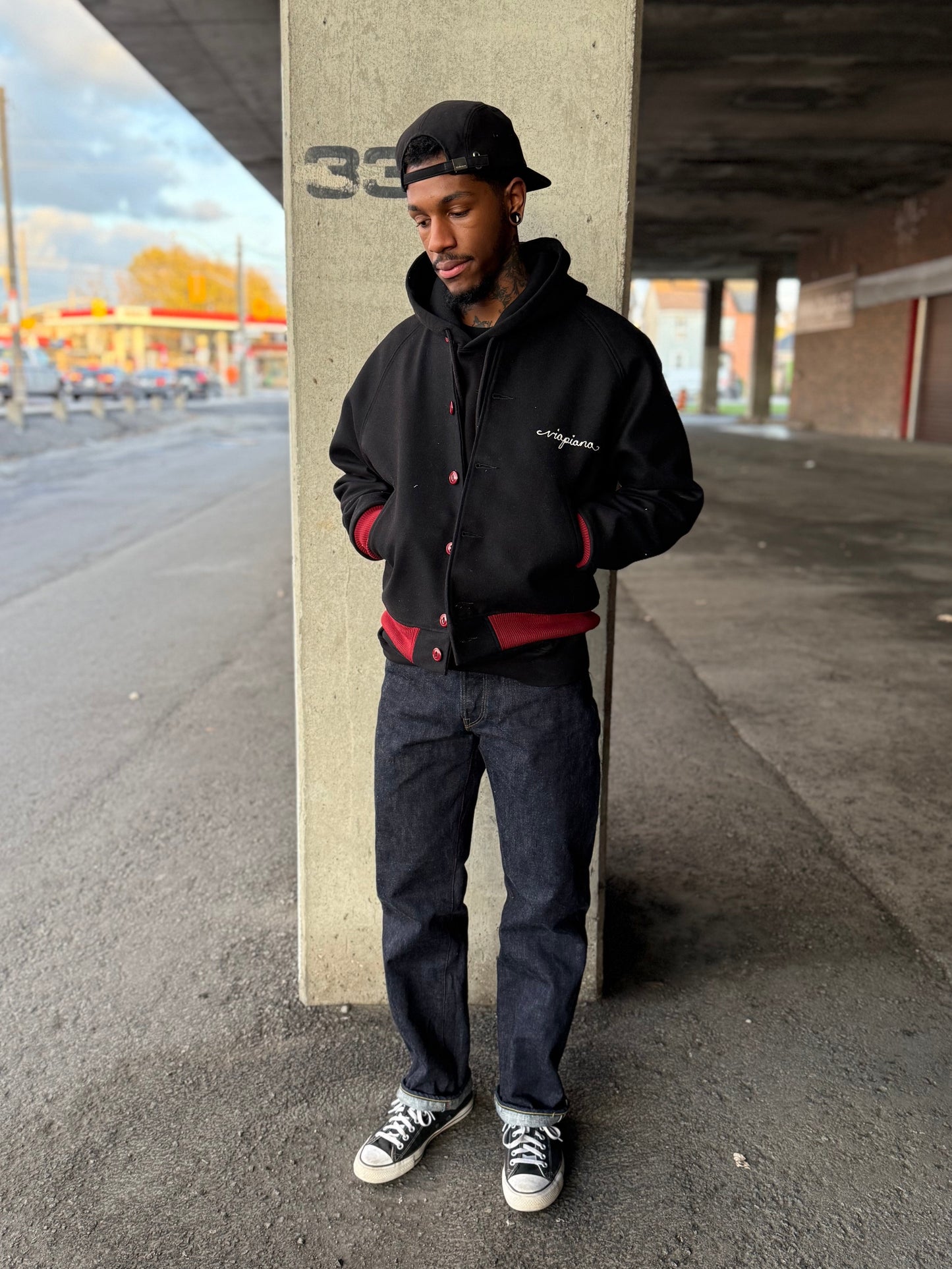 Myles is wearing the blk varsity jacket and the crested jeans